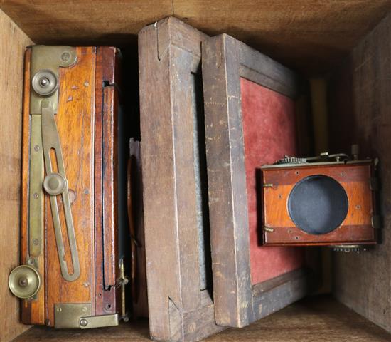 An early 20th century mahogany and brass bellows camera with three various lenses including an Anstigamat, boxed